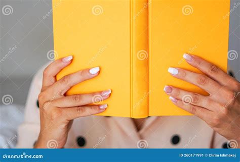Hands Holding a Book - Focusing a Yellow Book Stock Image - Image of ...