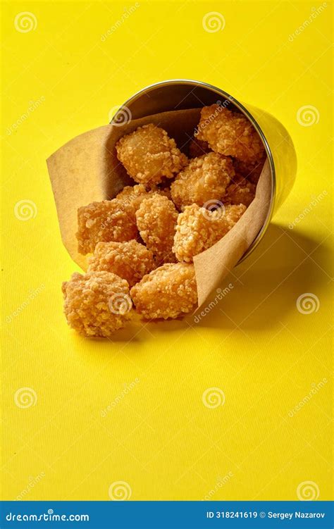 Crispy Fried Chicken Nuggets Spilling from Metal Bucket on Yellow Stock Image - Image of fillet ...