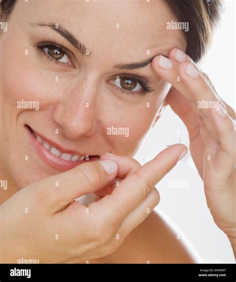 Woman putting in contact lens Stock Photo - Alamy