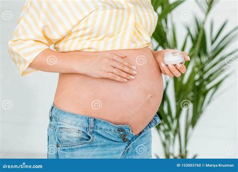 Pregnant Woman Putting Sunscreen on Her Belly. Close Up, Isolated Stock ...