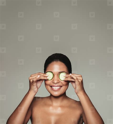Woman holding cucumber over eyes Photo (125115) - YouWorkForThem