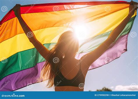 Girl Holding Rainbow Flag Opposite the Sun in Celebration of LGBT Pride ...