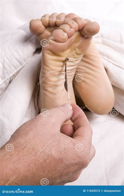 Man tickling womans feet stock photo. Image of female - 11653572