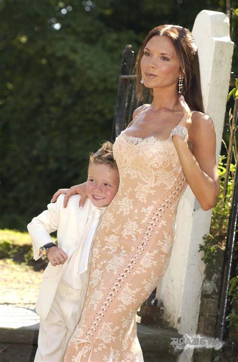 Victoria beckham goes braless in a plunging white floor length dress ...