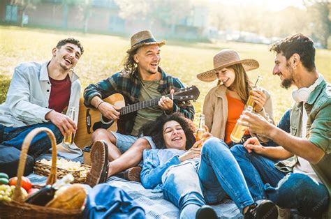 Premium Photo | Happy friends having picnic in the park Group of young people having fun ...