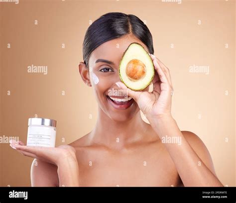 Skincare, avocado and cream with portrait of Indian woman in studio for ...