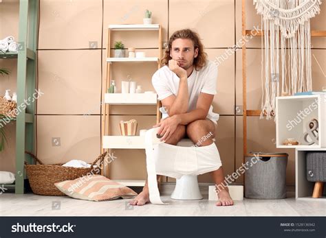 Young Man Sitting On Toilet Bowl Stock Photo (Edit Now) 1528136942