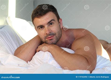 Handsome man naked in bed stock photo. Image of brazilian - 119762496