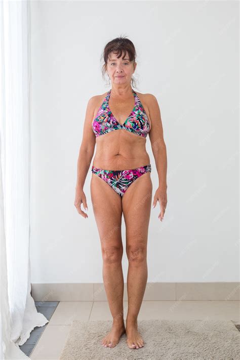 Premium Photo | Mature woman in colorful bikini white background