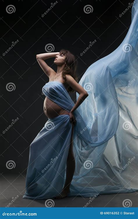 Young Beauty and Caucasian Pregnant Woman with Blue Silk on Gray Studio ...