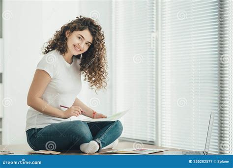 The Happy Woman Sitting on the Table and Drawing on the Paper. Stock ...