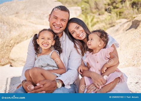 A Happy Mixed Race Family of Four Enjoying Fresh Air at the Beach. Hispanic Couple Bonding with ...