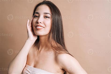 Beauty nude portrait of happy young beautiful asian woman with healthy dark long hair in top ...