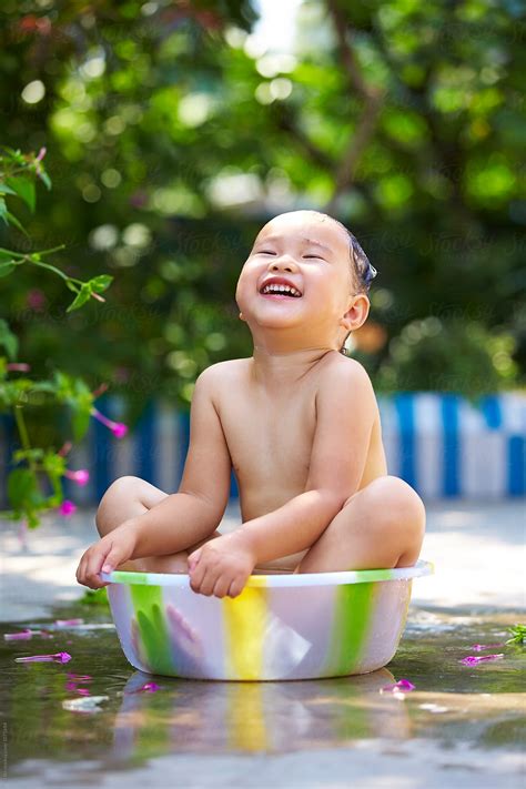 "Adorable Little Girl Sitting In The Basin Having Shower" by Stocksy ...
