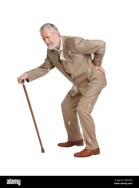 Senior man with walking cane suffering from back pain on white background Stock Photo - Alamy