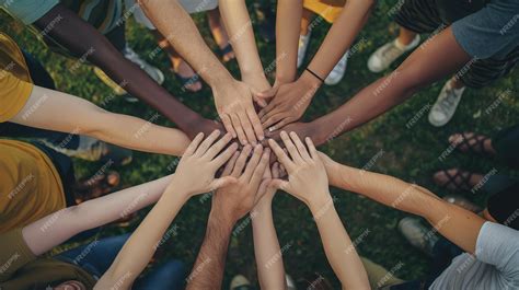 Diverse group of people holding hands in unity standing in a circle ...