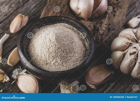 Garlic and Garlic Powder on Old Wood, Close Up Image Stock Image ...
