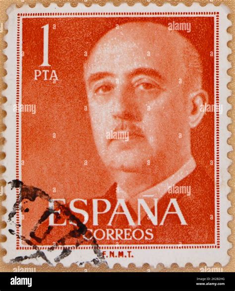 Photo of an orange 1 peseta Spanish postage stamp featuring an image of Francisco Franco ...