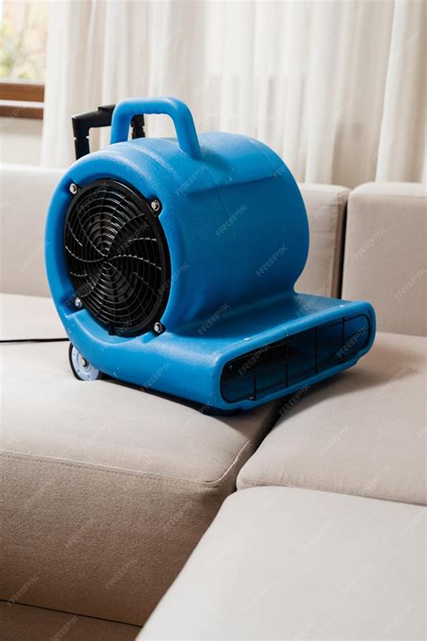 Premium Photo | Floor dryer blower fan machine drying wet couch after ...