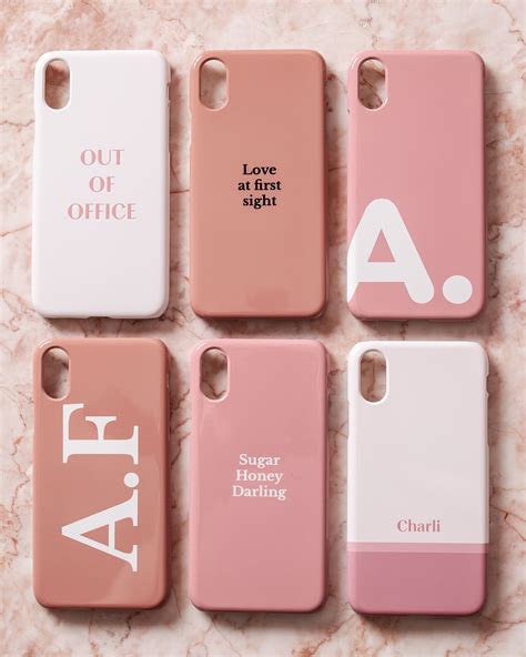 four iphone cases with the same name on them, all in pink and white colors