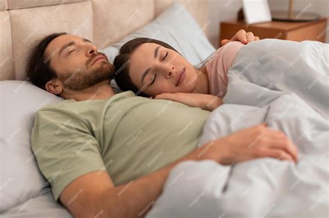 Premium Photo | Peaceful couple sleeping together in bed