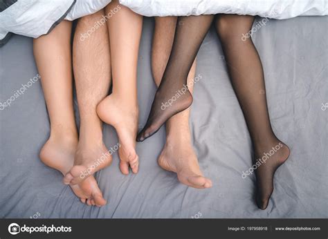 Close up feet of trio making love in bedroom Stock Photo by ©stockveres ...