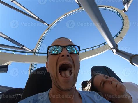 Man and woman on a roller coaster ride with emotion on their faces ...