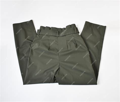 Premium Photo | Folded khaki green pants with belt flat lay on white