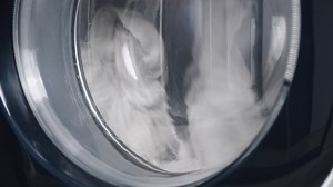 Washing machine washes dirty clothes. Washing clothing in domestic washing machine. Close up video of spinning drum washing machine