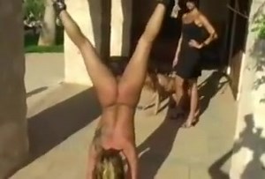 Women tied upside down and whipped