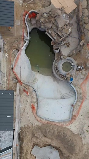 This backyard has an amazing slide, natural rock grotto, sunken fire pit, spa, putting green, and beautiful landscaping. What do you think of this backyard? #insanepools #lucaslagoons #poolbuilding #waterslide #backyardinspo #backyard #pool #luxurylife #luxuryhome | Lucas Lagoons