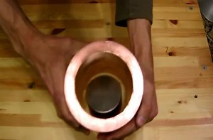 Magnets going through a copper pipe.