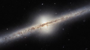 Pan of Spiral Galaxy UGC 10043 in Serpens | Hubble Space Telescope FriendsofNASA.org: What kind of astronomical object is this? It does not look quite like the kinds of galaxies, nebulae, star clusters or galaxy clusters that Hubble normally brings us images of. In fact, this is a spiral galaxy, named UGC 10043—we just happen to be seeing it directly from the side. Located roughly 150 million light-years from Earth in the constellation Serpens, UGC 10043 is one of the rare spiral galaxies that a