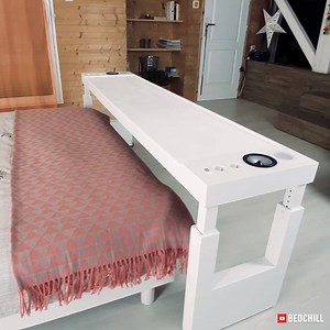 This sliding table makes your bed into an all-in-one entertainment center.. | Interesting Engineering
