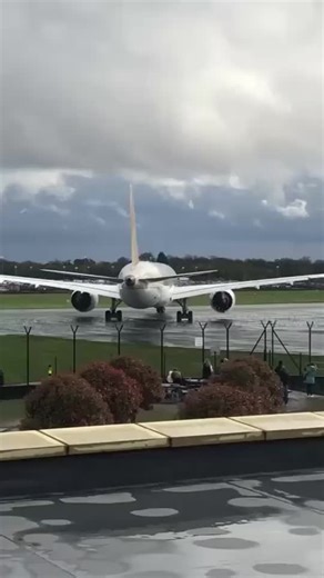 Emirates Aircraft Taxiing on a Wet Runway