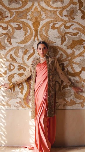 Where Style Checks-In 💃 Coral Deluxe - an exquisite organza jacket, embellished with antique gold work, accentuated with coral pink and pistachio green resham threadwork and mirror work. Worn over an elegant coral pink charmeuse silk saree, the ensemble gives a luxe aura and is truly a statement piece. ✨ Muse: @celina_arif Photography: @ayeshahshariq Videography: @murtazasipra Styling: @abdullah_sidiki Jewellery: @zaheenkamran Location: @ramadalahore #HSY #theworldofhsy #wherestylechecksin #fas