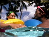 Close-up side view of couple wearing goggles as they kiss while...