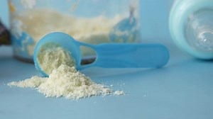 Download A scoop of powdered milk next to a bottle of milk for free