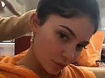 Kylie Jenner in orange jumpsuit as Ariel Tejada does her hair