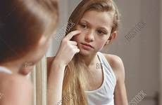 girl teenage body checking mirror her face