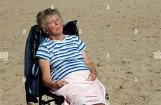 sunbathing beach senior lady alamy pembrokeshire wales tenby stock elderly person