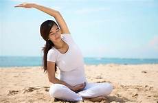 asian yoga pregnant doing pregnancy woman sea shore healthy baby winegar austin april lifestyle nutrition