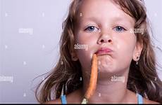 eating young girl carrots fresh sweet white background alamy child