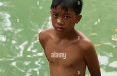 boy filipino swim pond alamy stands near after shopping cart