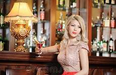 bar blonde woman stool legs elegant long attractive sitting dress hair nude model red showing heels gorgeous high her posing
