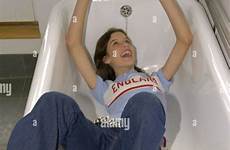 bath girl jeans tub shirt lying delighted dry alamy