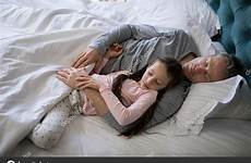 daughter sleeping father together stock wavebreakmedia depositphotos