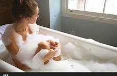 bath tub woman taking offset questions any stock