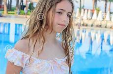teen cute girl pool dress long hair standing romantic bridge preview