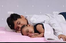 sleeping brother sister lying besides indian young his alamy
